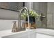 Close-up of a modern bathroom faucet with running water and decorative greenery at 507 Peach Tree Ln, Altamonte Springs, FL 32701