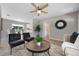 Inviting living room featuring stylish furniture, a ceiling fan, and seamless transition to the dining area at 507 Peach Tree Ln, Altamonte Springs, FL 32701