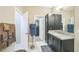 Well-appointed bathroom featuring granite countertops, modern fixtures, and a walk-in closet at 525 Narrow View Ln, Groveland, FL 34736