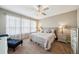 Cozy bedroom featuring a comfortable bed, matching nightstands, and plenty of natural light at 525 Narrow View Ln, Groveland, FL 34736