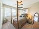 Bedroom with a wooden four-poster bed, neutral decor, and a window providing natural light at 525 Narrow View Ln, Groveland, FL 34736