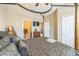 Bedroom featuring a luxurious four-poster bed, with an adjoining bathroom and walk-in closet at 525 Narrow View Ln, Groveland, FL 34736