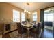 Elegant dining room with modern light fixture, a large dining table, and access to outdoor area at 525 Narrow View Ln, Groveland, FL 34736