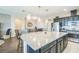 Open-concept kitchen featuring a large island with granite countertops and bar seating at 525 Narrow View Ln, Groveland, FL 34736