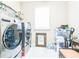 Laundry room featuring front loading washer and dryer, window and some storage containers at 525 Narrow View Ln, Groveland, FL 34736