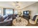 Bright living room features modern furniture, large windows, and stylish decor at 525 Narrow View Ln, Groveland, FL 34736