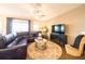 Spacious living room featuring a large sectional sofa, decorative rug, and entertainment center at 525 Narrow View Ln, Groveland, FL 34736