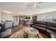 Spacious living room open to the kitchen and dining area, featuring wood floors at 525 Narrow View Ln, Groveland, FL 34736