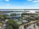 Aerial shot showcases lakeside condo community with tennis courts and tranquil lake views at 6330 Masters Blvd # N4, Orlando, FL 32819