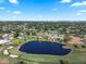 Picturesque aerial view of homes overlooking a beautiful pond and golf course, blending leisure and luxury at 6330 Masters Blvd # N4, Orlando, FL 32819