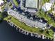 Aerial view of lakeside condos with boat docks and tennis courts, offering a luxurious and active lifestyle at 6330 Masters Blvd # N4, Orlando, FL 32819