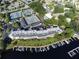 Aerial showcasing lake access, boat slips, tennis courts, and lush landscape near the complex at 6330 Masters Blvd # N4, Orlando, FL 32819
