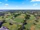 Picturesque aerial view showcases a verdant golf course winding through a residential community on a clear day at 6330 Masters Blvd # N4, Orlando, FL 32819