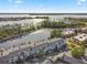 Aerial view showcasing the property's lakeside location with boat docks, lush landscaping and building at 6330 Masters Blvd # N4, Orlando, FL 32819