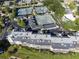 Scenic aerial view of condo community featuring tennis courts, mature trees, and manicured landscaping at 6330 Masters Blvd # N4, Orlando, FL 32819