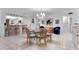 Bright dining area featuring tile floors, natural lighting and seating for six around a glass table at 6330 Masters Blvd # N4, Orlando, FL 32819