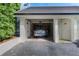 Attached garage with a Tesla vehicle inside, plus exterior door to unit at 6330 Masters Blvd # N4, Orlando, FL 32819
