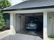 Attached garage featuring a modern vehicle inside of the home for secure parking at 6330 Masters Blvd # N4, Orlando, FL 32819
