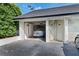 Attached garage with a Tesla vehicle inside, plus exterior door at 6330 Masters Blvd # N4, Orlando, FL 32819