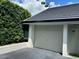 Attached garage with decorative white paneling and modern lamp fixture at 6330 Masters Blvd # N4, Orlando, FL 32819