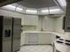 Bright white kitchen with stainless steel refrigerator, and decorative ceiling at 6330 Masters Blvd # N4, Orlando, FL 32819
