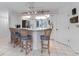 An eat-in kitchen with tile floors, a breakfast bar with seating, and white cabinetry at 6330 Masters Blvd # N4, Orlando, FL 32819