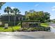 Bay Hill Condominiums stone sign enhanced by colorful flowers and manicured landscaping at the entrance at 6330 Masters Blvd # N4, Orlando, FL 32819