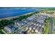 Community aerial highlighting the rows of townhomes and its picturesque setting near a lake at 635 Cheval Ln, Debary, FL 32713