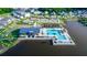 Aerial view of the community pool, amenities and clubhouse set by a serene lake at 635 Cheval Ln, Debary, FL 32713