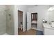 Well-lit bathroom featuring a glass-enclosed shower and a vanity at 635 Cheval Ln, Debary, FL 32713