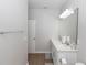 Bright bathroom featuring double sinks with white cabinets and modern fixtures at 635 Cheval Ln, Debary, FL 32713