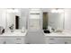 Dual vanity bathroom featuring separate mirrors and white countertops, enhanced by natural light at 635 Cheval Ln, Debary, FL 32713