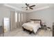 Comfortable bedroom with a tray ceiling, a ceiling fan, and a bench at the foot of the bed at 635 Cheval Ln, Debary, FL 32713
