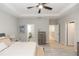 Spacious bedroom showcasing tray ceiling, wood floors, and open doorways at 635 Cheval Ln, Debary, FL 32713