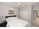 Bedroom featuring a bed with white bedding and a view of closet and hallway at 635 Cheval Ln, Debary, FL 32713
