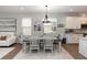 Bright dining room features modern chandelier, and seating for six at 635 Cheval Ln, Debary, FL 32713