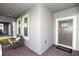 Cozy front porch with comfortable seating, a brick floor, and an exterior front door at 635 Cheval Ln, Debary, FL 32713