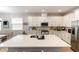Open kitchen with stainless steel appliances, modern cabinets, and stone countertops at 635 Cheval Ln, Debary, FL 32713