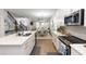 Open kitchen with island, stainless appliances, modern cabinets, and dining area at 635 Cheval Ln, Debary, FL 32713
