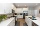 Kitchen features stainless appliances, white cabinets, stone countertops, and prep island at 635 Cheval Ln, Debary, FL 32713