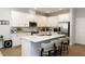 Modern kitchen with stainless steel appliances, large island, and bar stool seating at 635 Cheval Ln, Debary, FL 32713