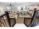 View from stairs of home's open floor plan featuring modern dining and living area at 635 Cheval Ln, Debary, FL 32713