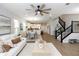 Open concept living space with sleek modern design, and hardwood floors seamlessly blending the living area with the kitchen at 635 Cheval Ln, Debary, FL 32713
