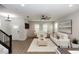 Bright living room featuring neutral walls, wood floors, and stylish furniture with large windows at 635 Cheval Ln, Debary, FL 32713