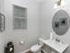 Bathroom features modern vanity, decorative mirror, and updated lighting at 635 Cheval Ln, Debary, FL 32713