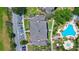 Overhead shot of a meticulously landscaped community with a sparkling pool, lush greenery and ample parking at 7689 Heritage Crossing Way # 202, Reunion, FL 34747