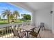 Balcony featuring outdoor furniture with lush golf course views and swaying palms at 7689 Heritage Crossing Way # 202, Reunion, FL 34747