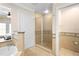 Bright bathroom featuring a glass enclosed shower, soaking tub and neutral toned tile floors at 7689 Heritage Crossing Way # 202, Reunion, FL 34747