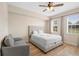Bedroom view features a comfortable bed with neutral decor and hardwood flooring at 7689 Heritage Crossing Way # 202, Reunion, FL 34747