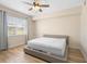 Bright bedroom features hardwood flooring and natural light from the window at 7689 Heritage Crossing Way # 202, Reunion, FL 34747